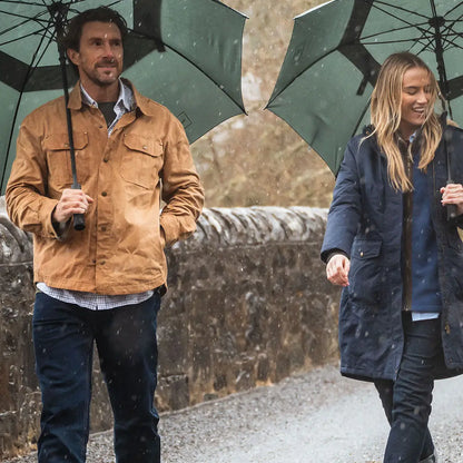 Two people with umbrellas wearing Hoggs of Fife Huntly Waxed Canvas Utility Overshirt