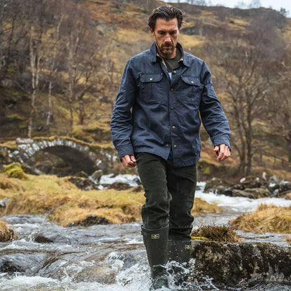 Man in wading boots wearing the Hoggs of Fife Huntly Waxed Canvas Utility Overshirt