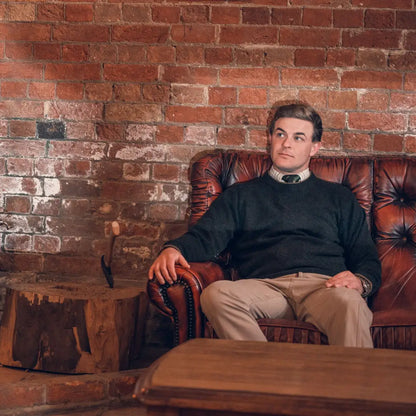 Man in a leather armchair wearing the Jack Pyke Ashcombe 100% Lambswool Pullover