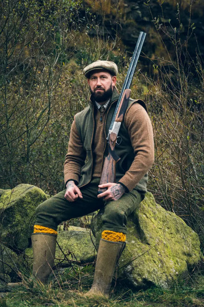 Hunter with shotgun wearing a Jack Pyke Ashcombe Lambwool Zipknit Pullover
