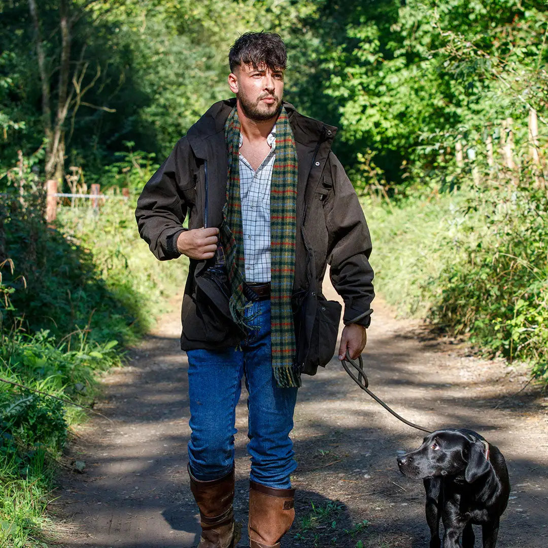Man walking dog in a Jack Pyke Ashcombe Jacket enjoying the outdoors