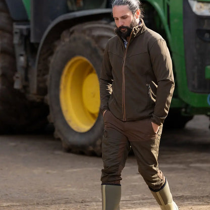 Man in workwear wearing Jack Pyke County Softshell Jacket for outdoor tasks