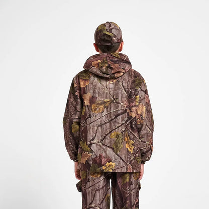 Kid in Jack Pyke Junior Jacket Evo with leaf camo pattern