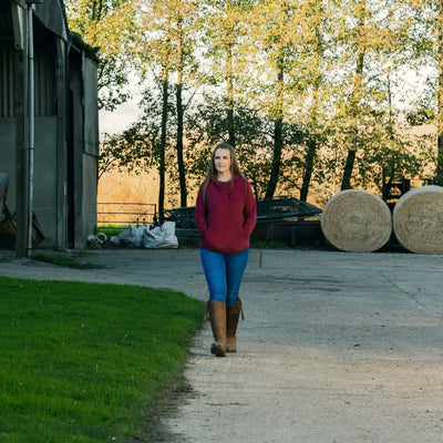 Woman in maroon hoodie from Jack Pyke Ladies Fleece Hoodie collection