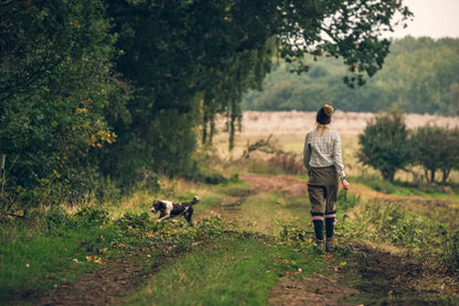 Woman walking with dog wearing Jack Pyke Ladies Shooting Socks for style and comfort