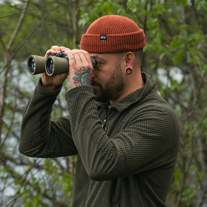 Man using binoculars while wearing a Jack Pyke Lightweight Z Fleece Jacket