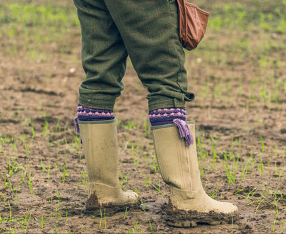 Muddy rubber boots paired perfectly with Jack Pyke Pebble Shooting Socks for outdoor adventures
