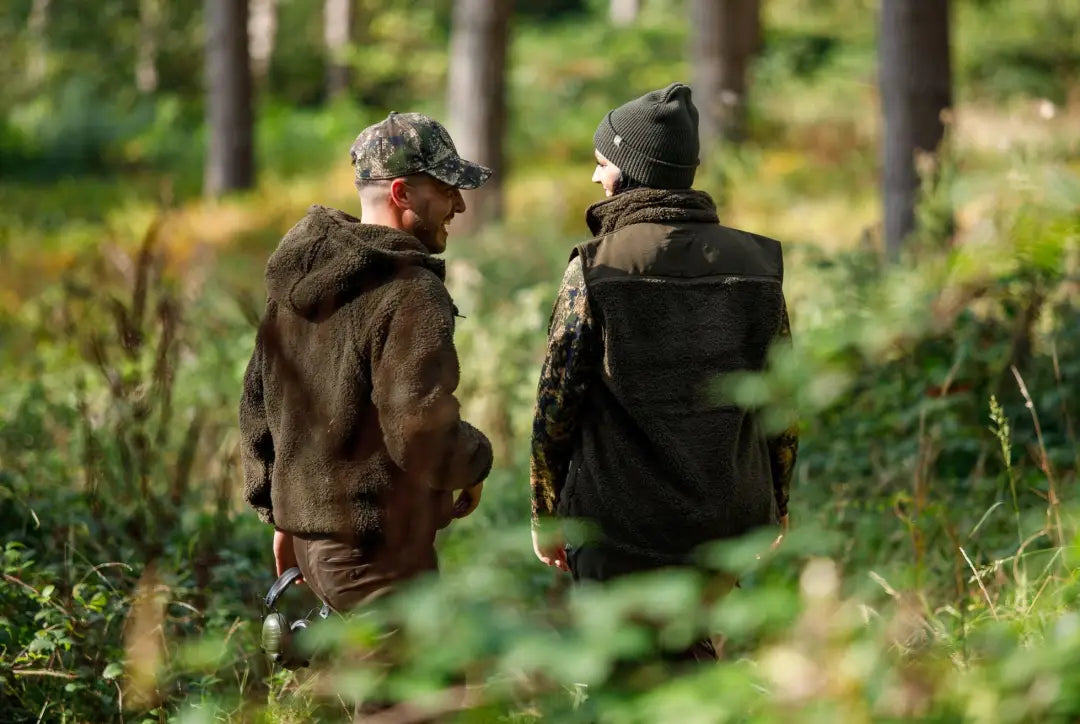 Two people wearing Jack Pyke Sherpa Fleece Gilet enjoying the outdoors