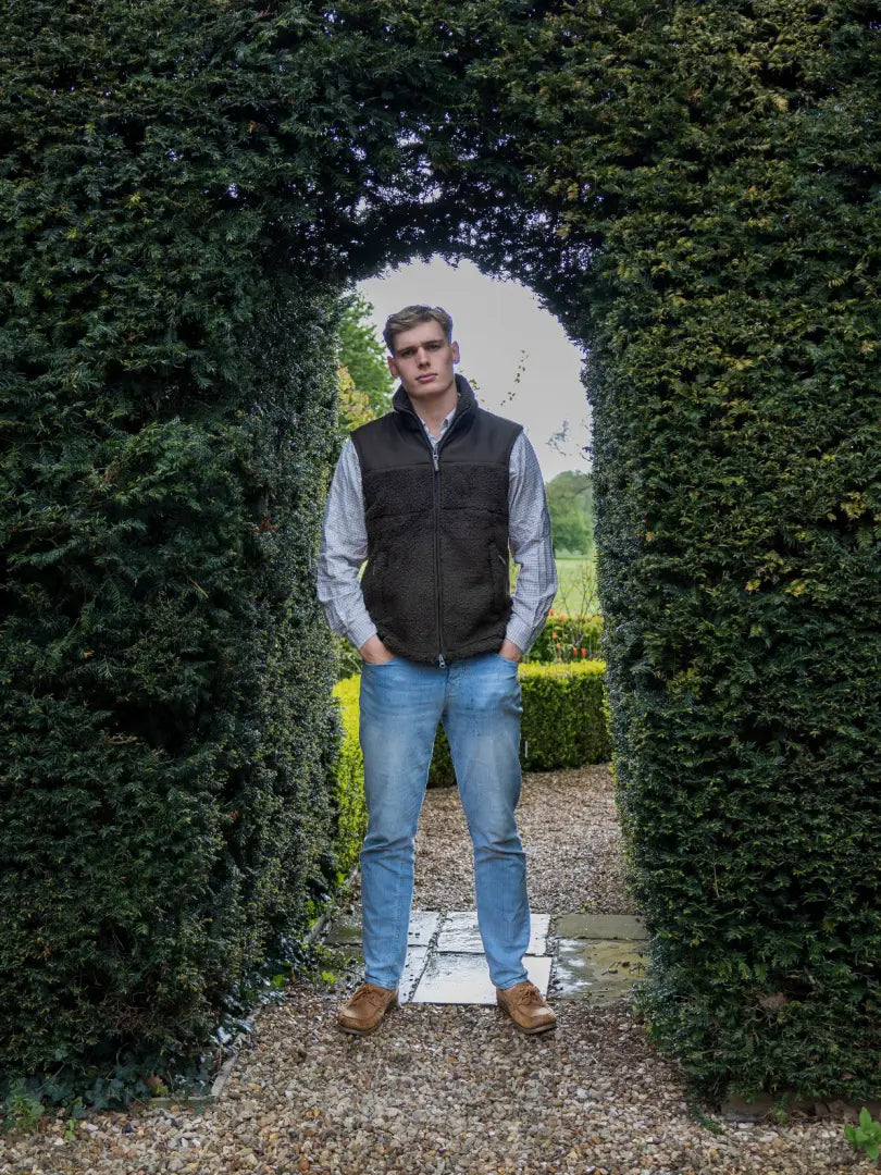 Man in vest and jeans wearing a cozy Jack Pyke Sherpa Fleece Gilet