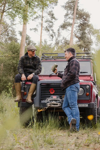 Red off-road vehicle next to Jack Pyke Tundra Shirt showcasing outdoor adventure vibes