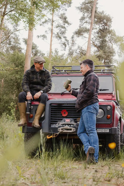 Red off-road vehicle paired with Jack Pyke Tundra Shirt for outdoor adventure vibes