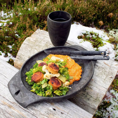 Rustic wooden plate with food featuring Kupilka Cutlery Set for country clothing lovers