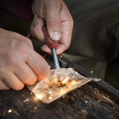 Fire starter in action with Kupilka Firesteel, the perfect gear for country clothing adventures