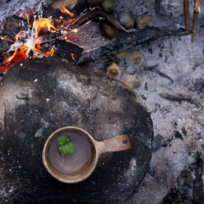 Wooden Kupilka Large Cup with liquid and herb, perfect for country clothing and outdoor hunting