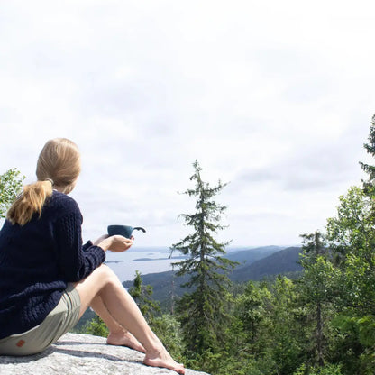 Woman enjoying a Kupilka Large Cup, overlooking a stunning landscape with natural fibre
