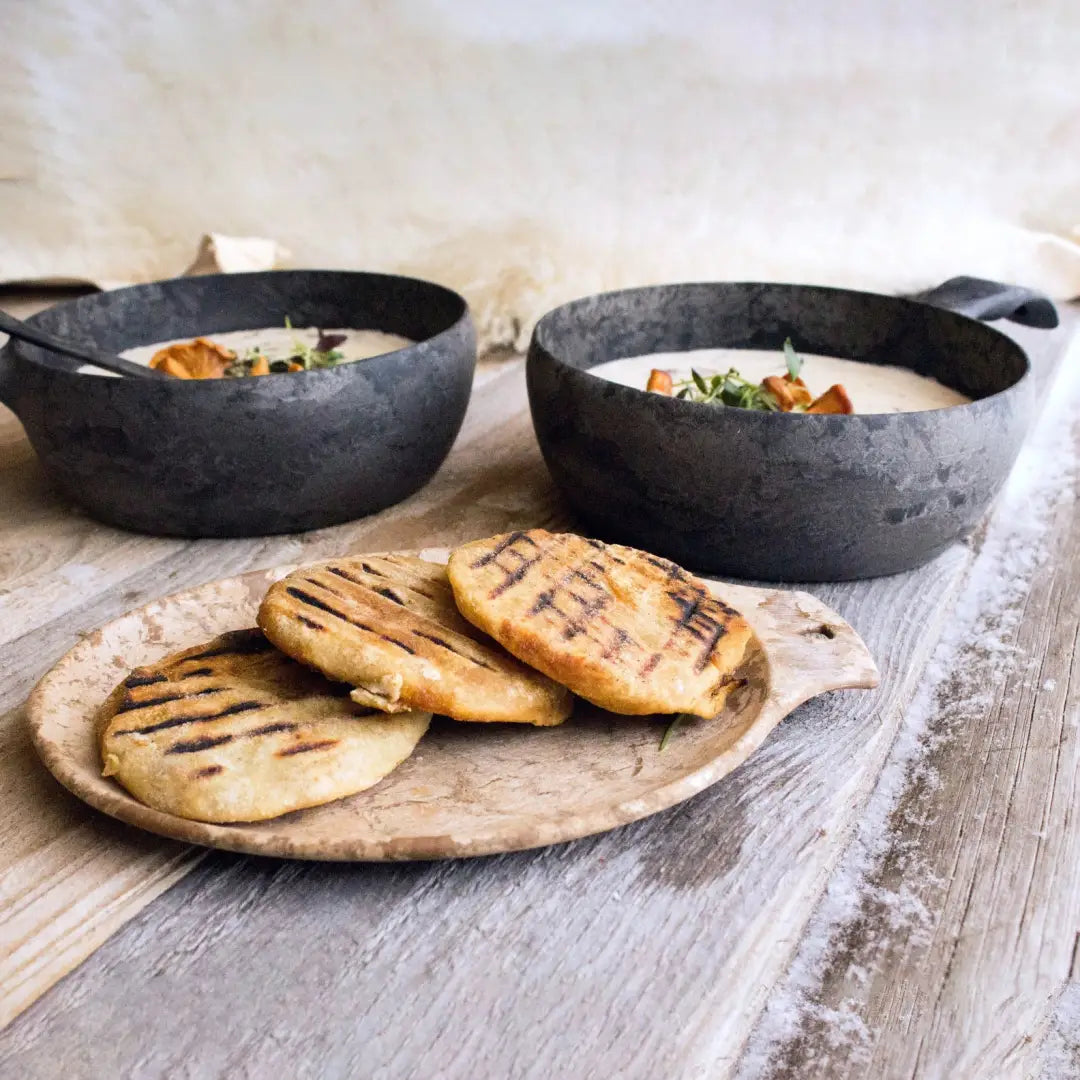 Rustic soup bowls and grilled flatbreads on Kupilka Small Plate for outdoor dining vibes