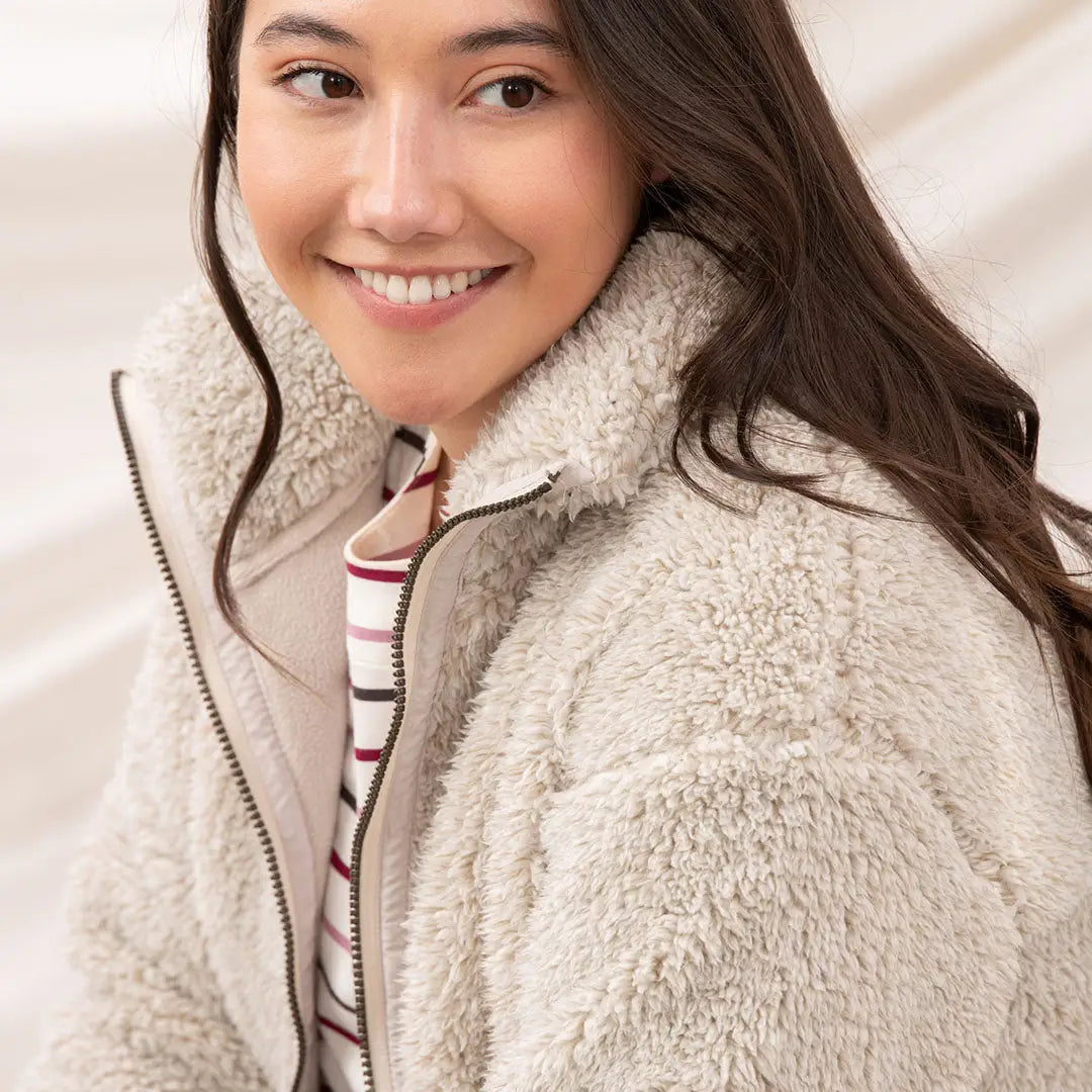Woman in Lighthouse Cobh zip fleece and striped shirt, perfect for country clothing