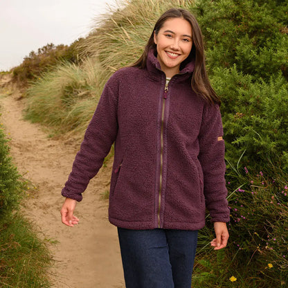 Smiling woman in Lighthouse Cobh zip fleece, perfect for country clothing adventures