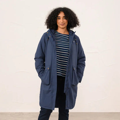 Woman wearing Lighthouse Imogen Ladies Coat in navy blue with striped shirt and dark pants
