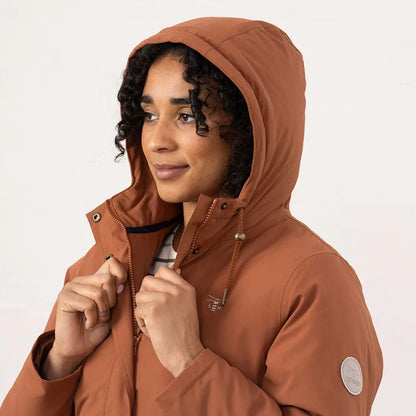 Woman in rust-colored Lighthouse Imogen Ladies Coat with hood, stylish Imogen ladies coat