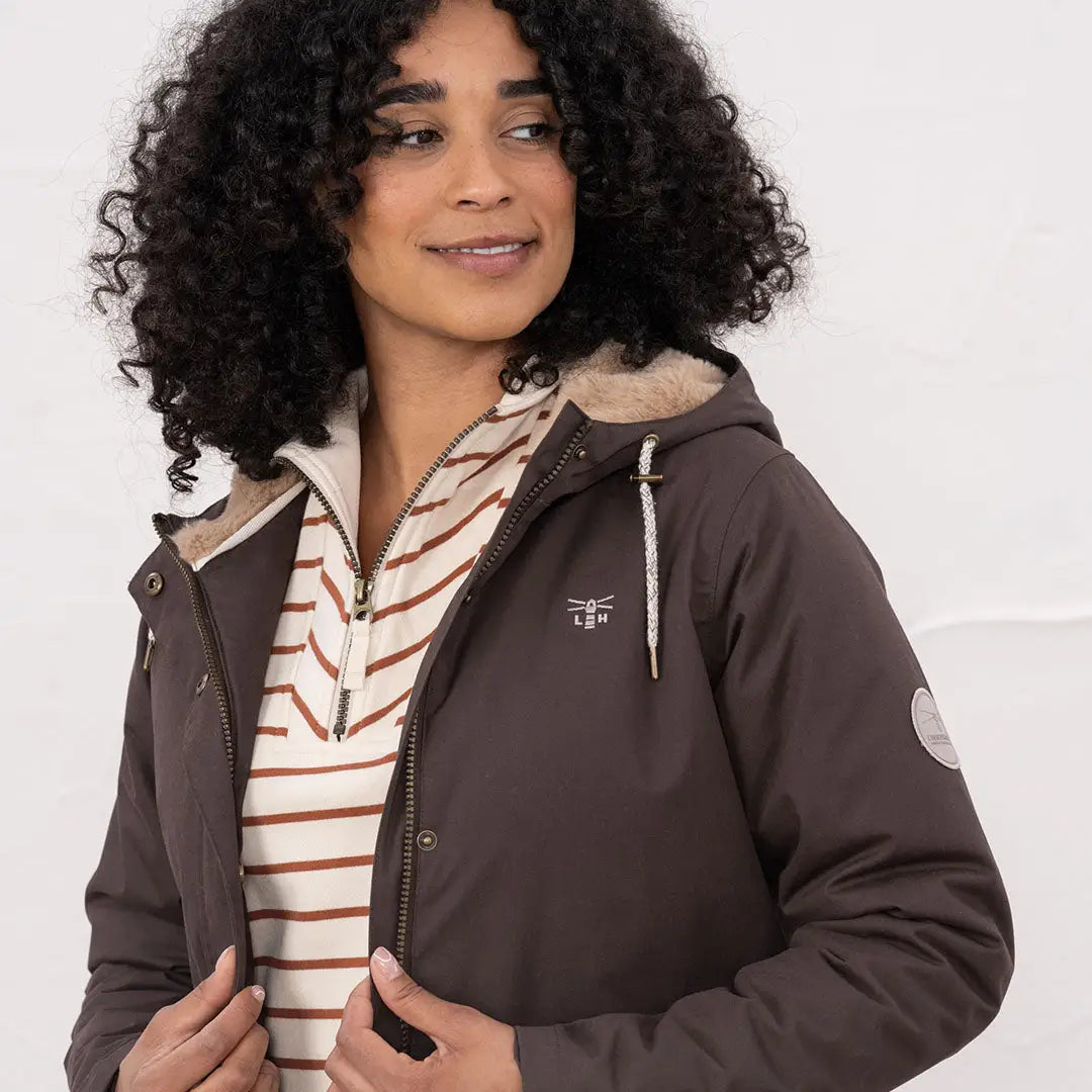 Woman wearing Lighthouse Isobel Coat with hood, faux fur lining, and striped shirt