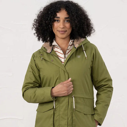Woman wearing Lighthouse Isobel Coat in olive green insulated parka with fur-lined hood
