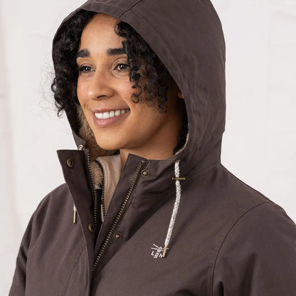 Woman wearing a Lighthouse Isobel Coat dark brown hooded jacket with light lining
