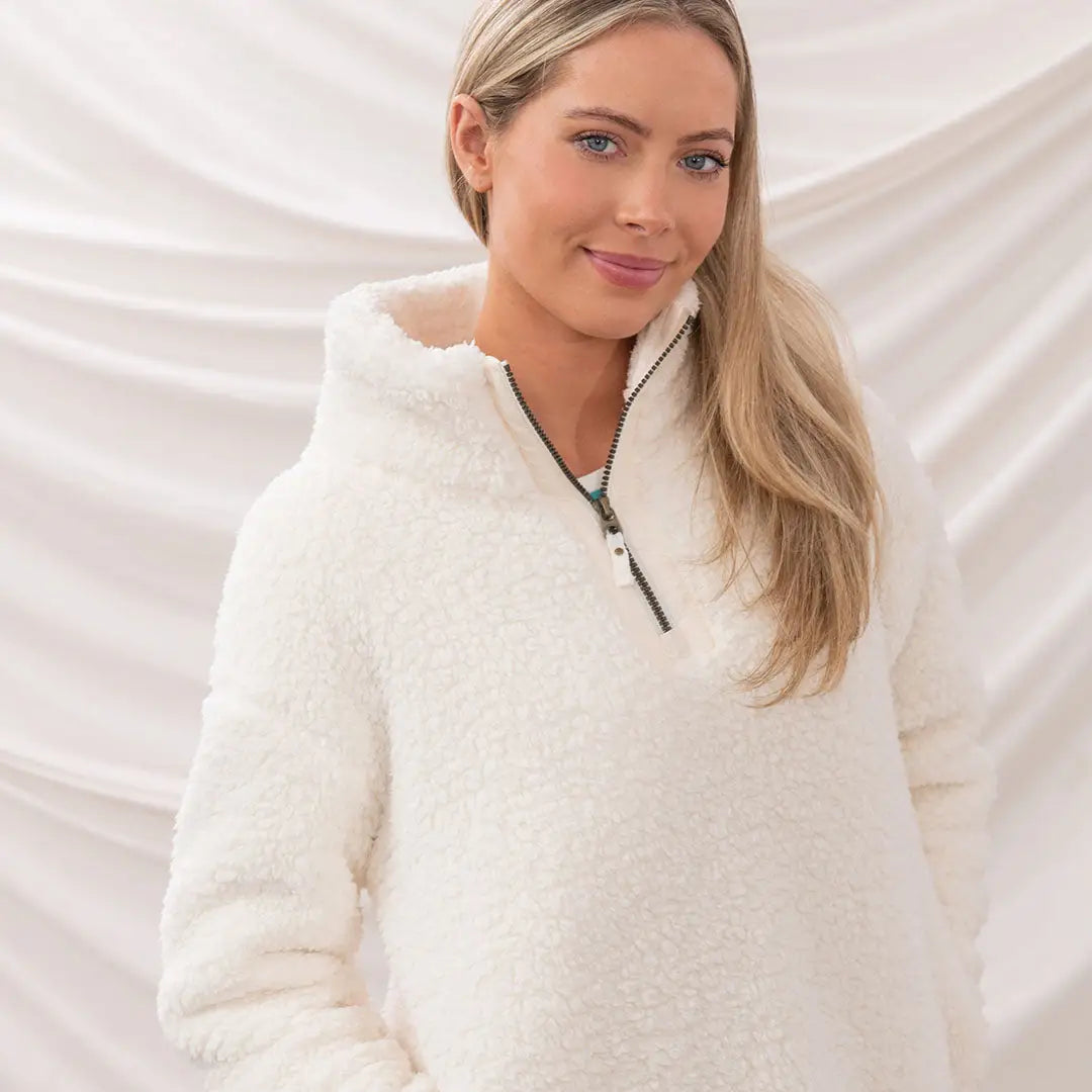 Woman in a cozy Lighthouse Ladies Bay Fleece pullover, perfect for chilly days