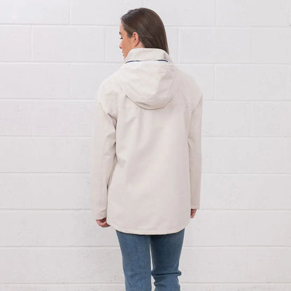 Woman in a beige hooded jacket from the Lighthouse Ladies Beachcomber II Coat