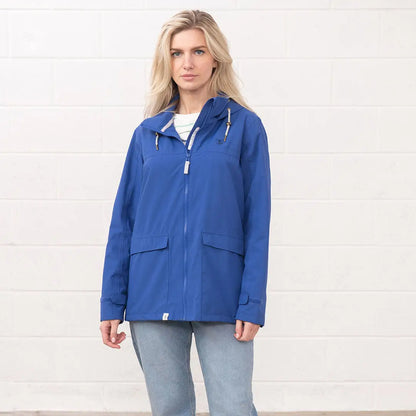 Woman in Lighthouse Ladies Beachcomber II Coat, showcasing a stylish blue hooded raincoat