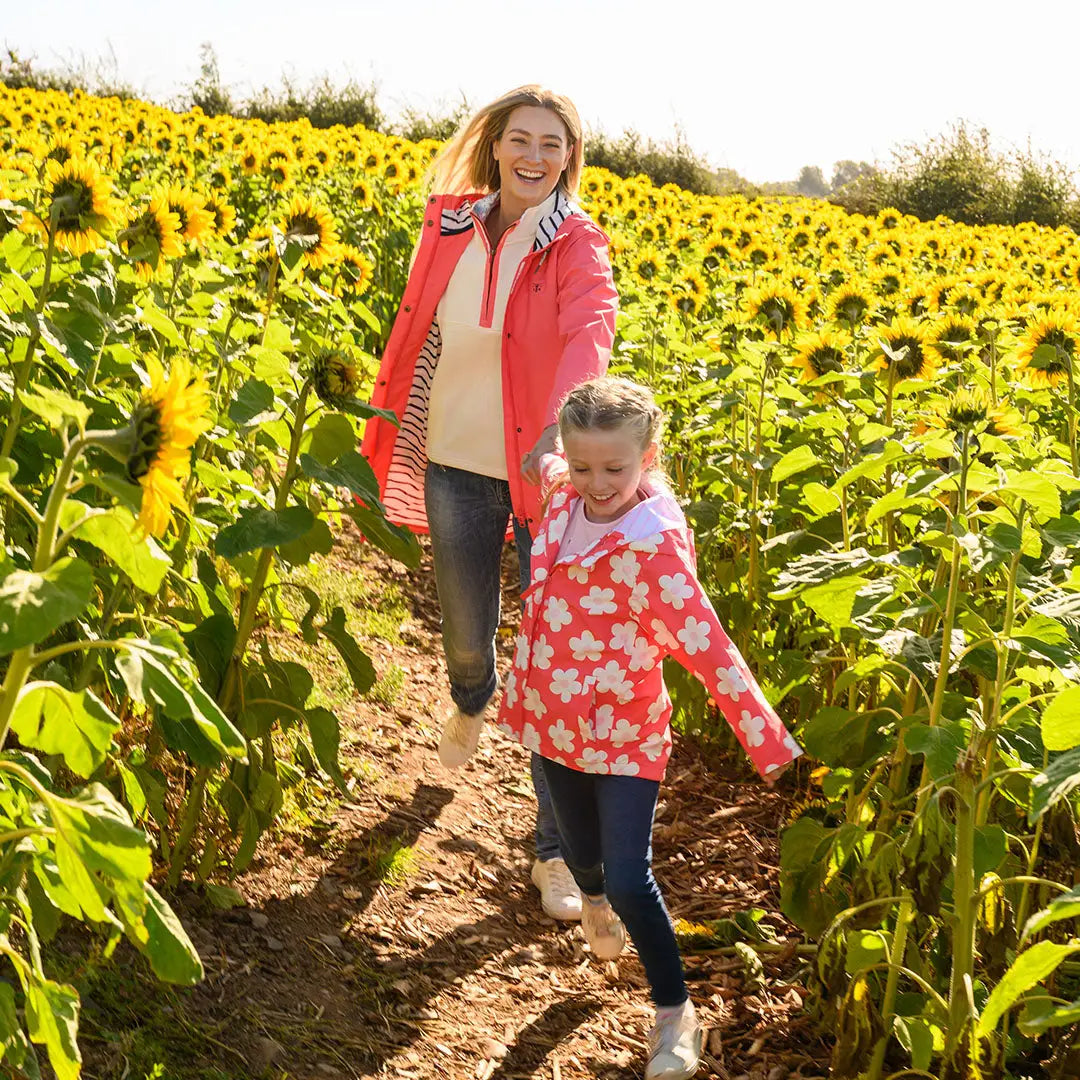 Mother and daughter with sunflowers in lighthouse ladies beachcomber long II coat