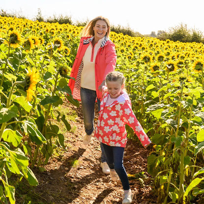 Mother and daughter with sunflowers in lighthouse ladies beachcomber long II coat