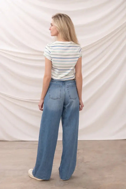 Lighthouse Ladies Causeway T-Shirt with blue green stripes and wide-leg jeans