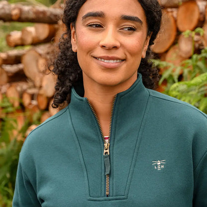 Woman in lighthouse ladies coral jersey quarter-zip pullover showcasing lighthouse ladies coral style
