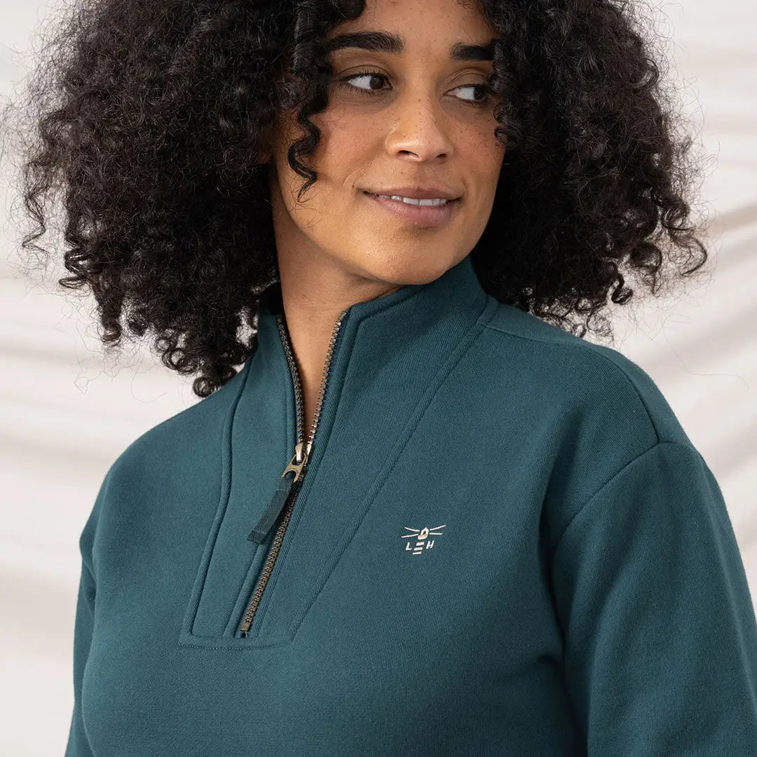 Lighthouse Ladies Coral Jersey sweatshirt worn by woman in dark teal quarter-zip style