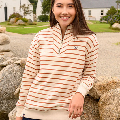 Woman wearing Lighthouse Ladies Coral Jersey quarter-zip sweatshirt in cream and brown stripes