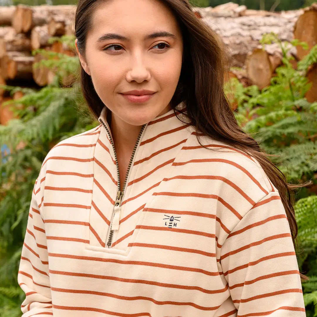 Woman wearing Lighthouse Ladies Coral Jersey quarter-zip sweatshirt in cream and brown stripes