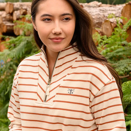 Woman wearing Lighthouse Ladies Coral Jersey quarter-zip sweatshirt in cream and brown stripes