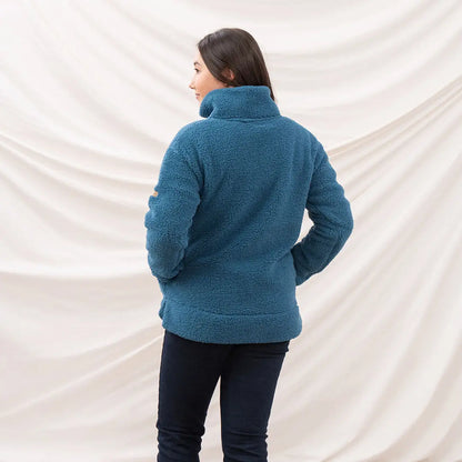 Lighthouse Ladies Coast Fleece woman wearing teal half-zip pullover and dark pants