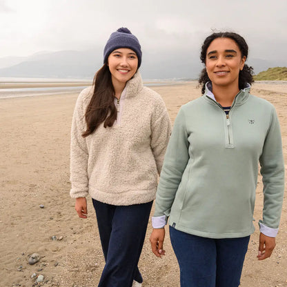 Lighthouse Ladies Half-Zip Coast Fleece women walking on sandy beach in comfy quarter-zip