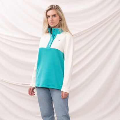 Woman wearing Lighthouse Ladies Haven II Jersey color-blocked fleece pullover for cozy style