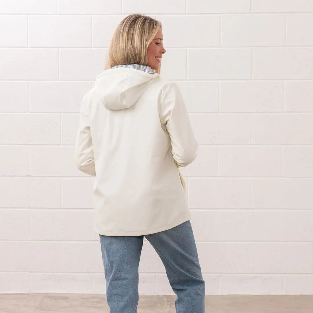 Woman in a hooded jacket and jeans wearing the stylish Lighthouse Ladies Lucy Coat