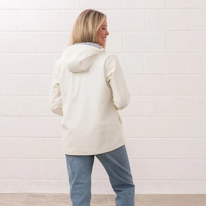 Woman in a hooded jacket and jeans wearing the stylish Lighthouse Ladies Lucy Coat