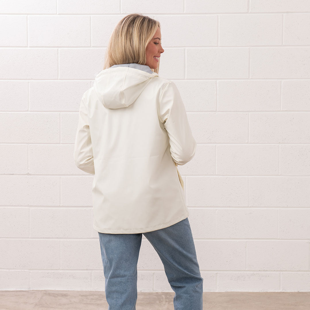 Woman in a hooded jacket and jeans wearing the stylish Lighthouse Ladies Lucy Coat