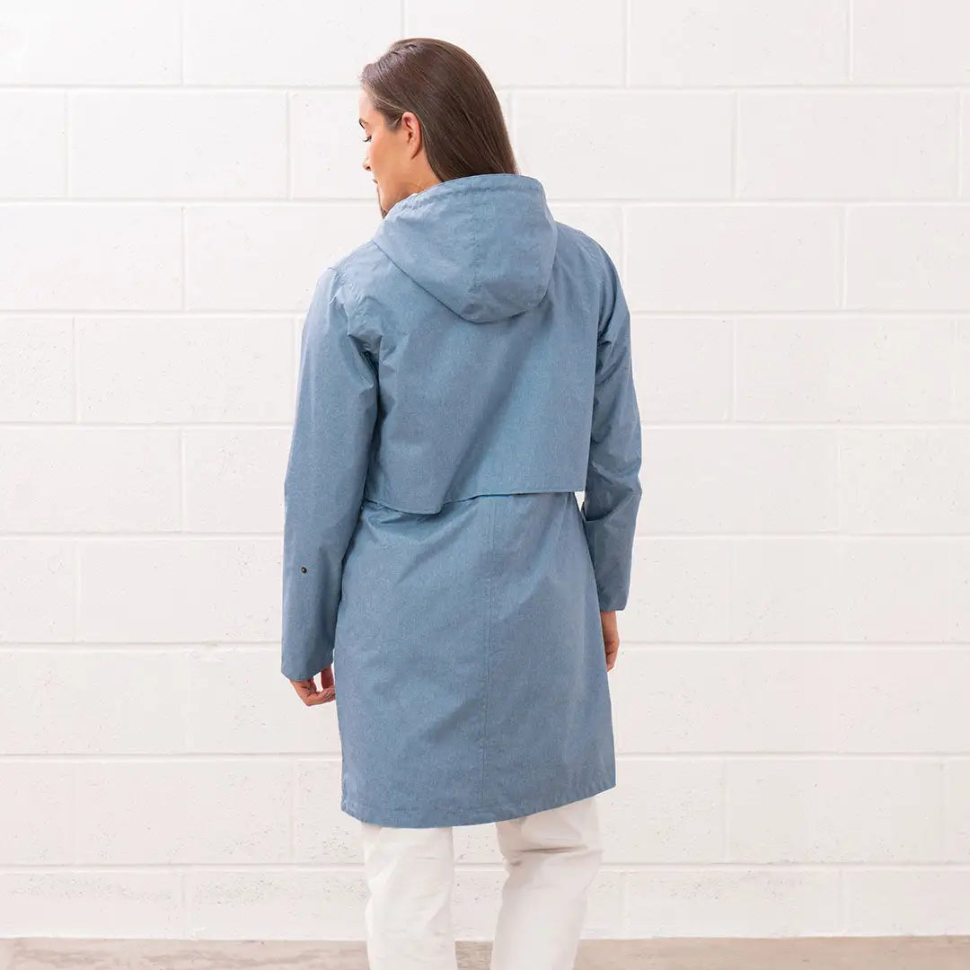 Woman in a blue hooded raincoat wearing the Lighthouse Ladies Pippa Coat