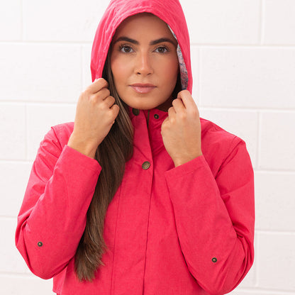 Woman wearing a Lighthouse Ladies Pippa Coat in pink, perfect for rainy days