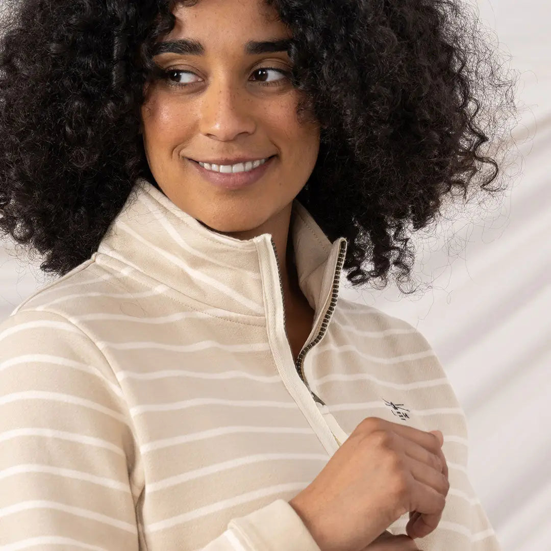 Lighthouse Ladies Shore II Jersey woman wearing beige and white striped quarter-zip pullover