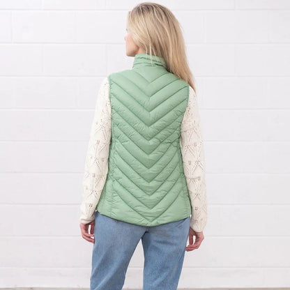 Woman rocking a Lighthouse Laurel Gilet in light green, perfect for stylish layering