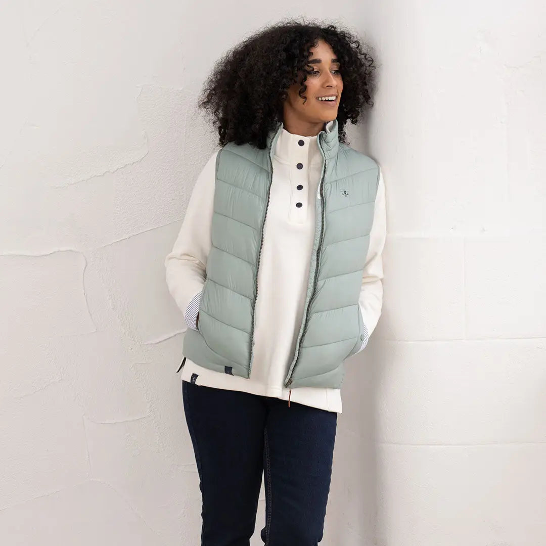 Lighthouse Laurel ladies puffer vest over cream shirt and dark pants, stylish look