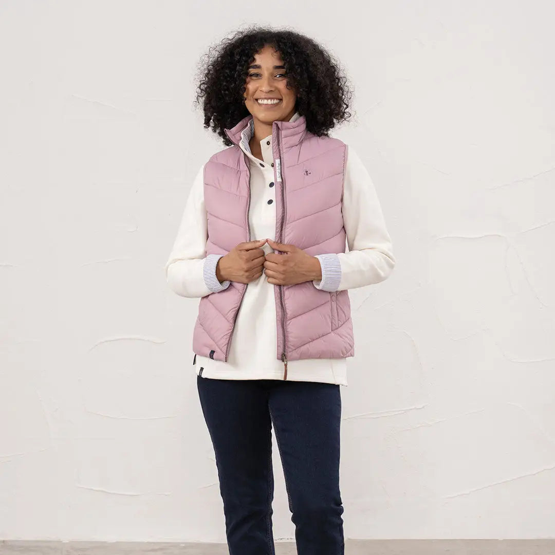 Lighthouse Laurel ladies pink quilted vest with cream top and dark blue trousers